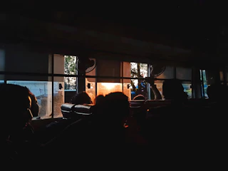 A comfortable intercity bus parked at a terminal during sunset.