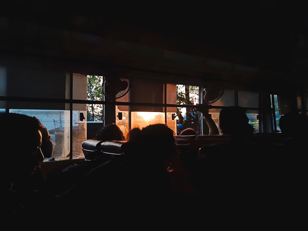 a group of people sitting in front of a window