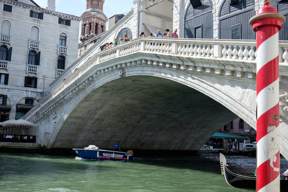 a boat is going under a bridge in venice