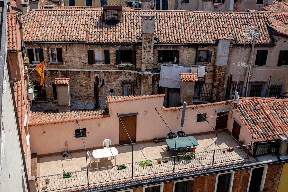 a balcony with a table and chairs on it