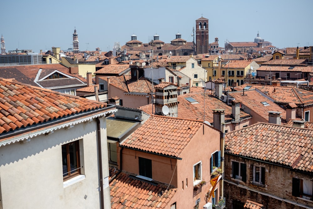 a view of a city with rooftops and a clock tower