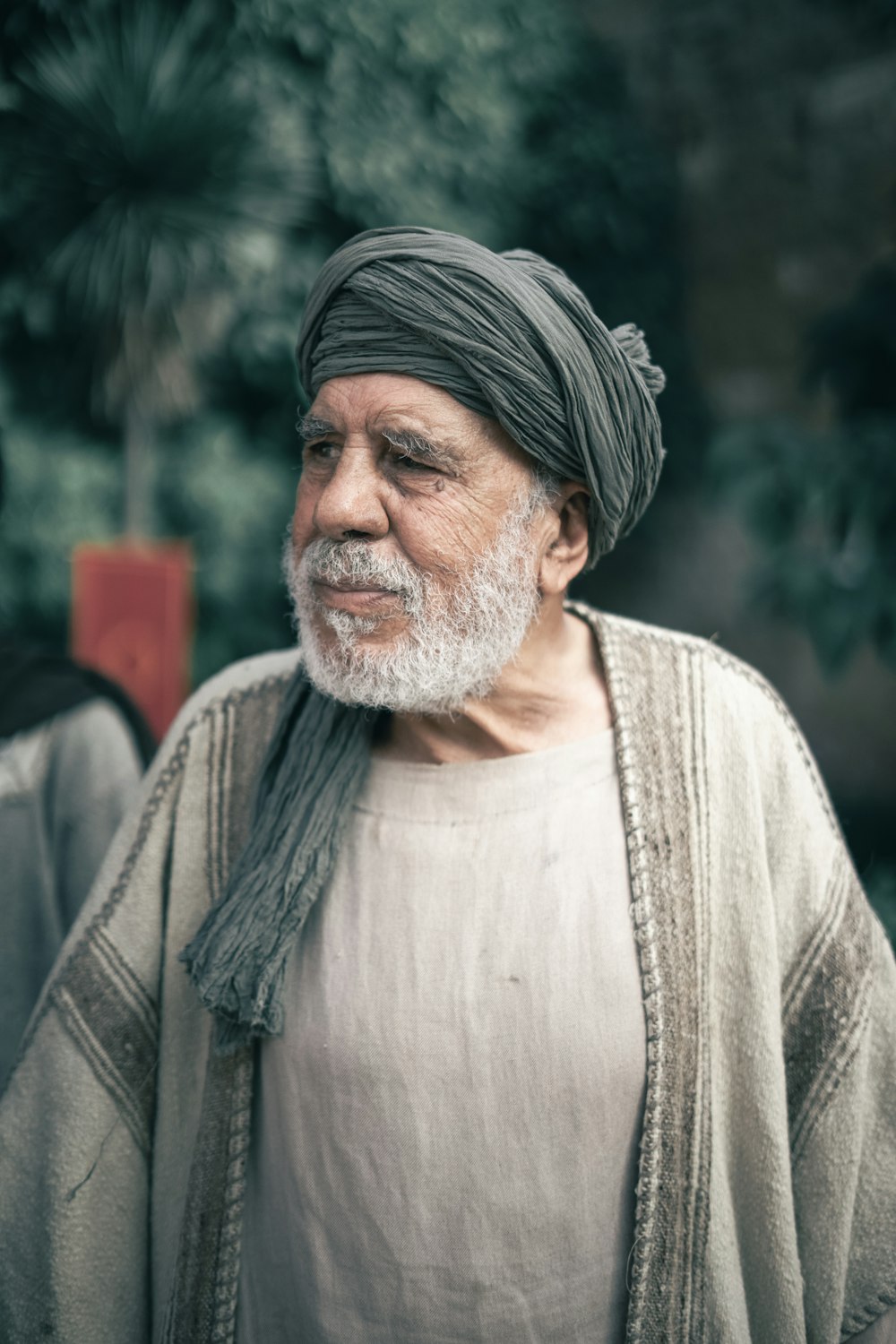 a man with a white beard and a gray turban