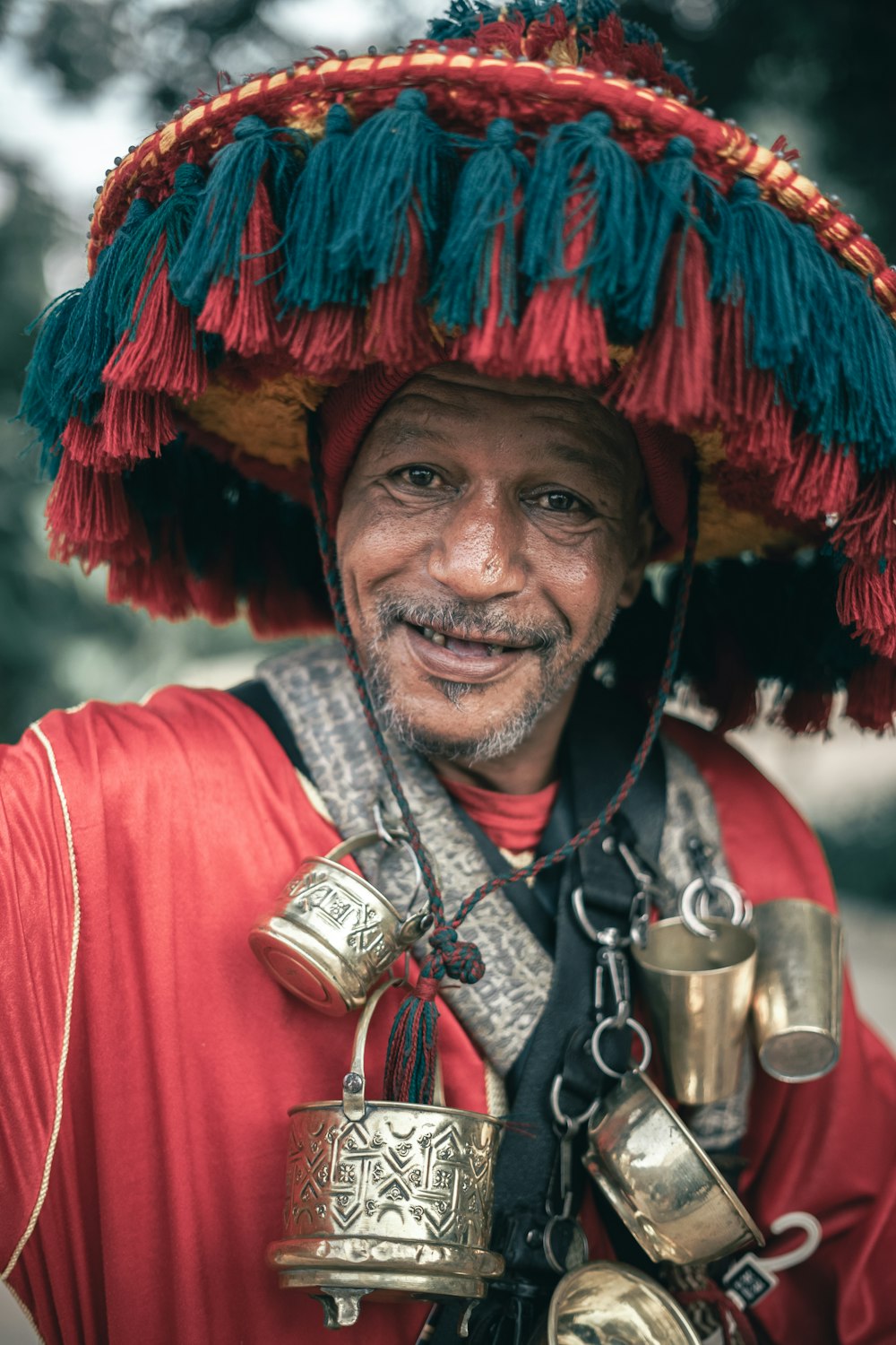 a man wearing a hat with bells on it