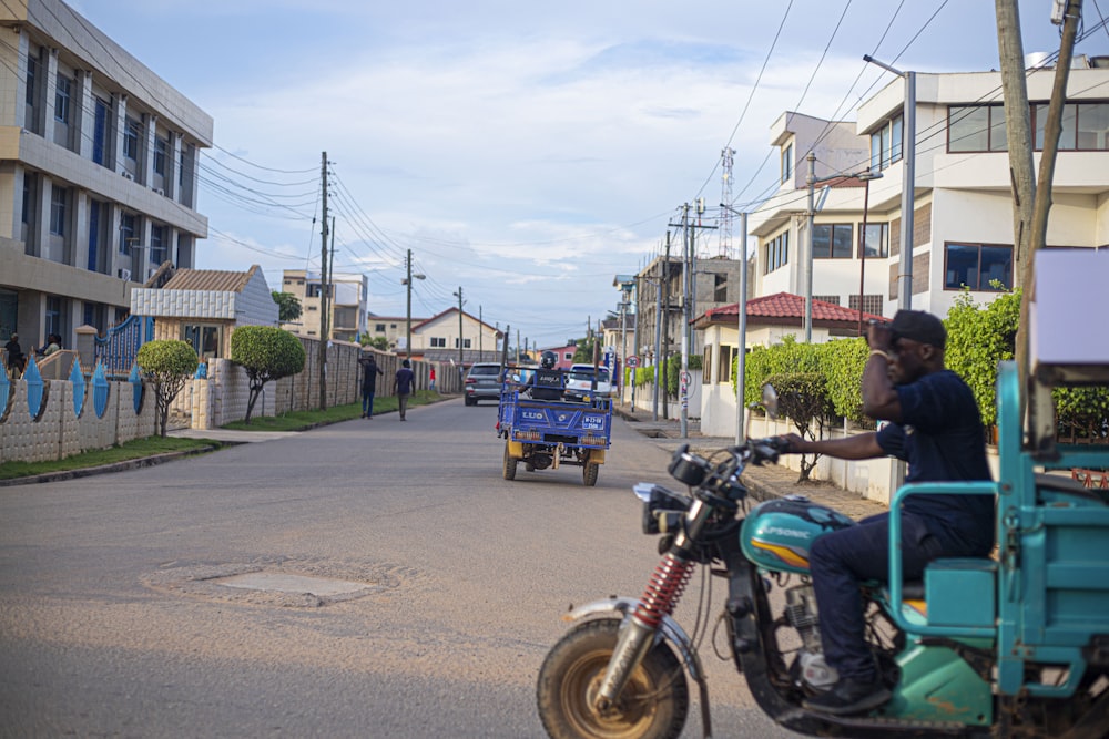 a man riding a motorcycle down a street