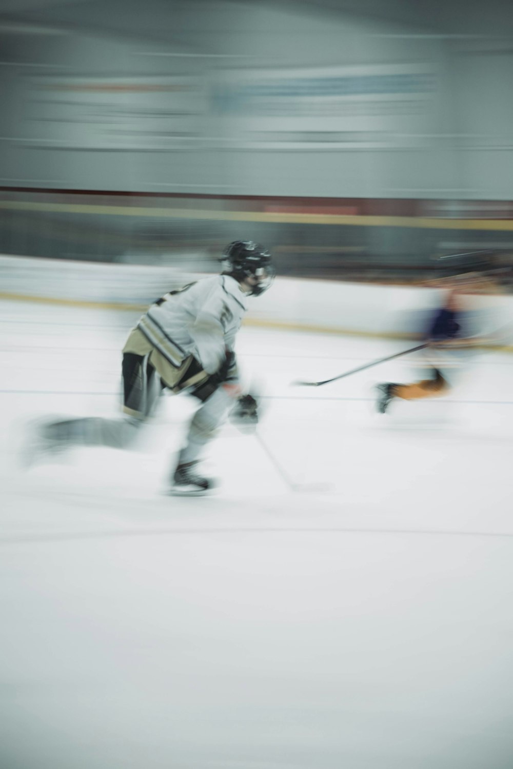 a person on a ice rink with a hockey stick