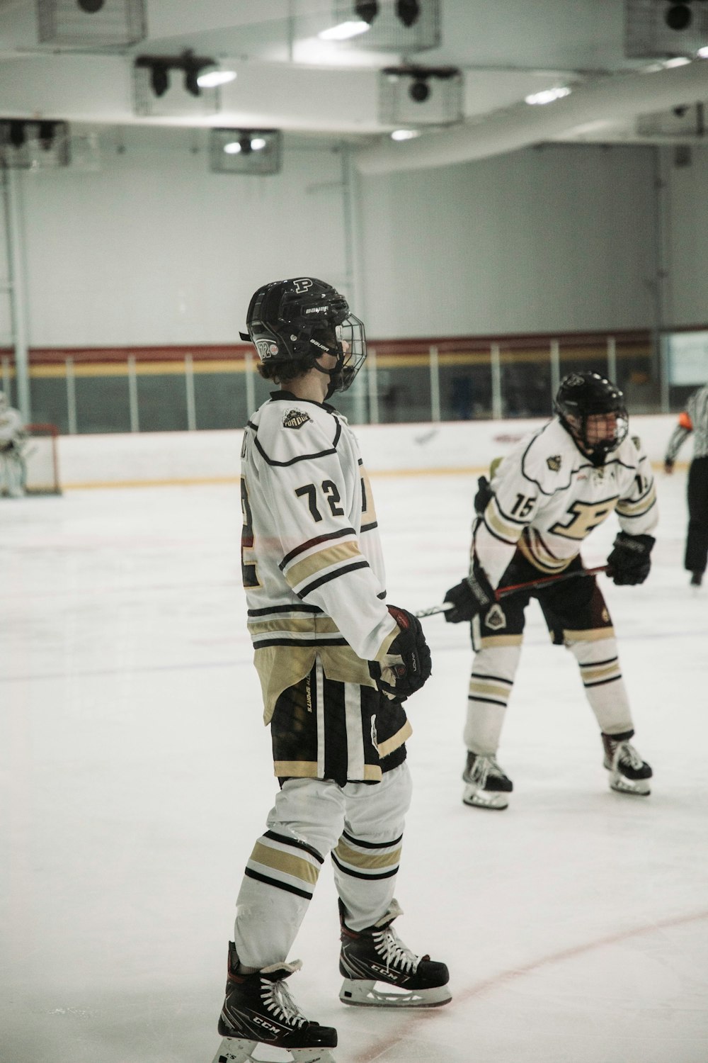 a group of young men playing a game of ice hockey