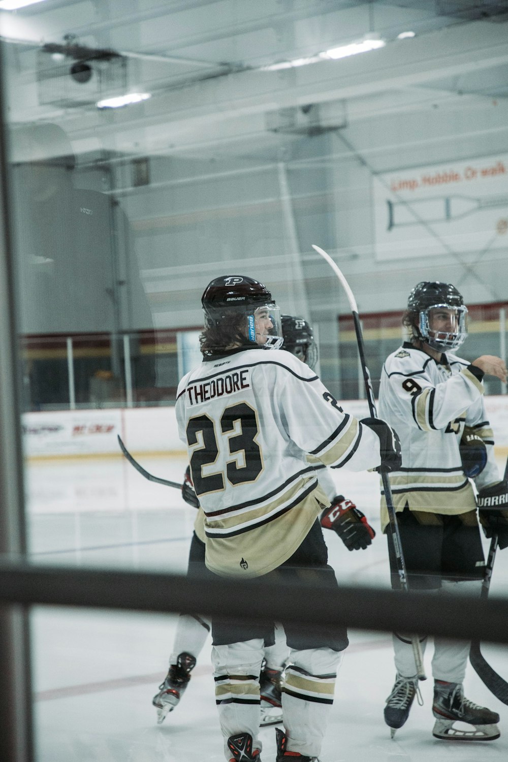 a group of young men playing a game of ice hockey