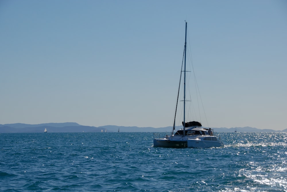 a sailboat in the middle of a body of water