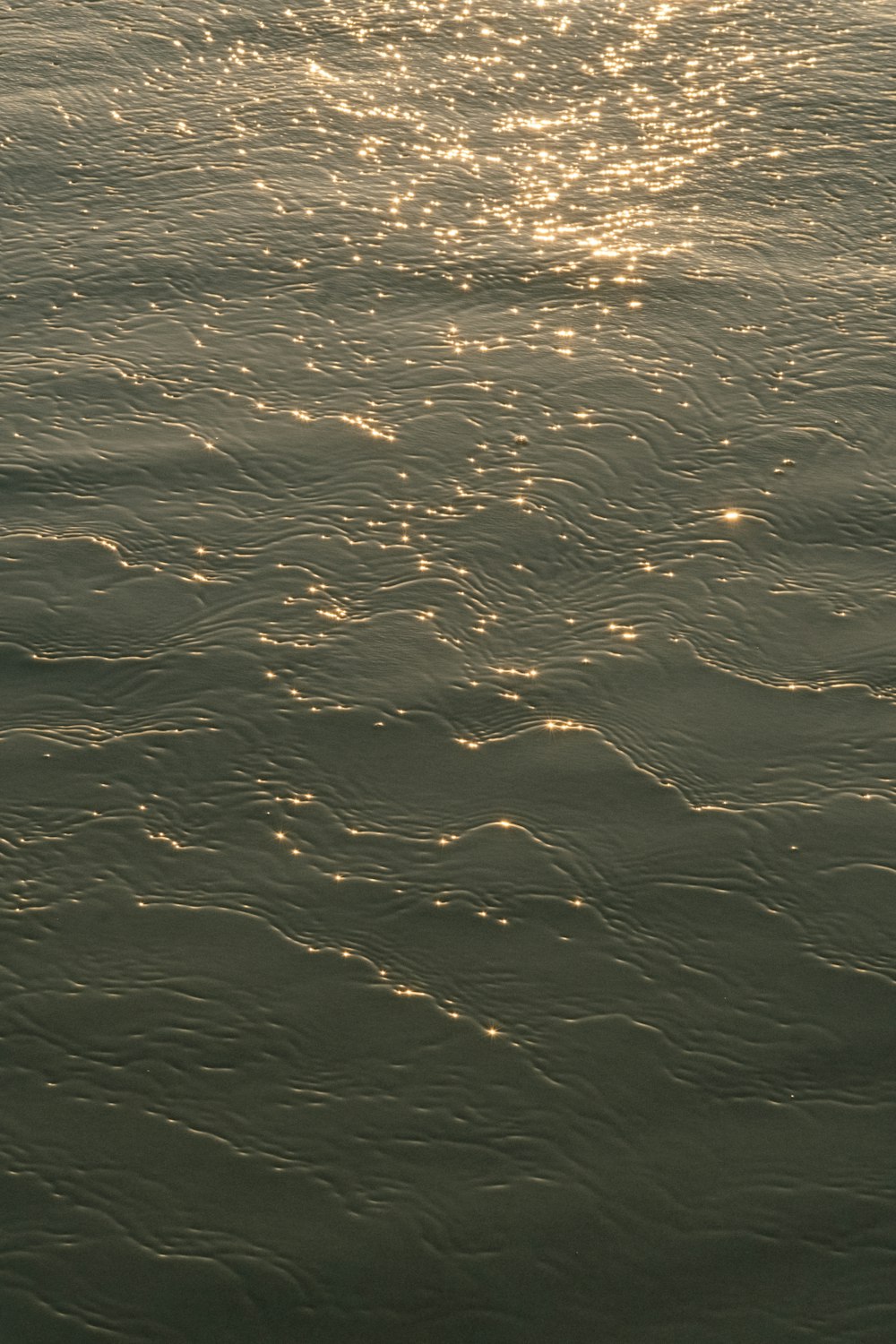 a large body of water with a boat in the distance