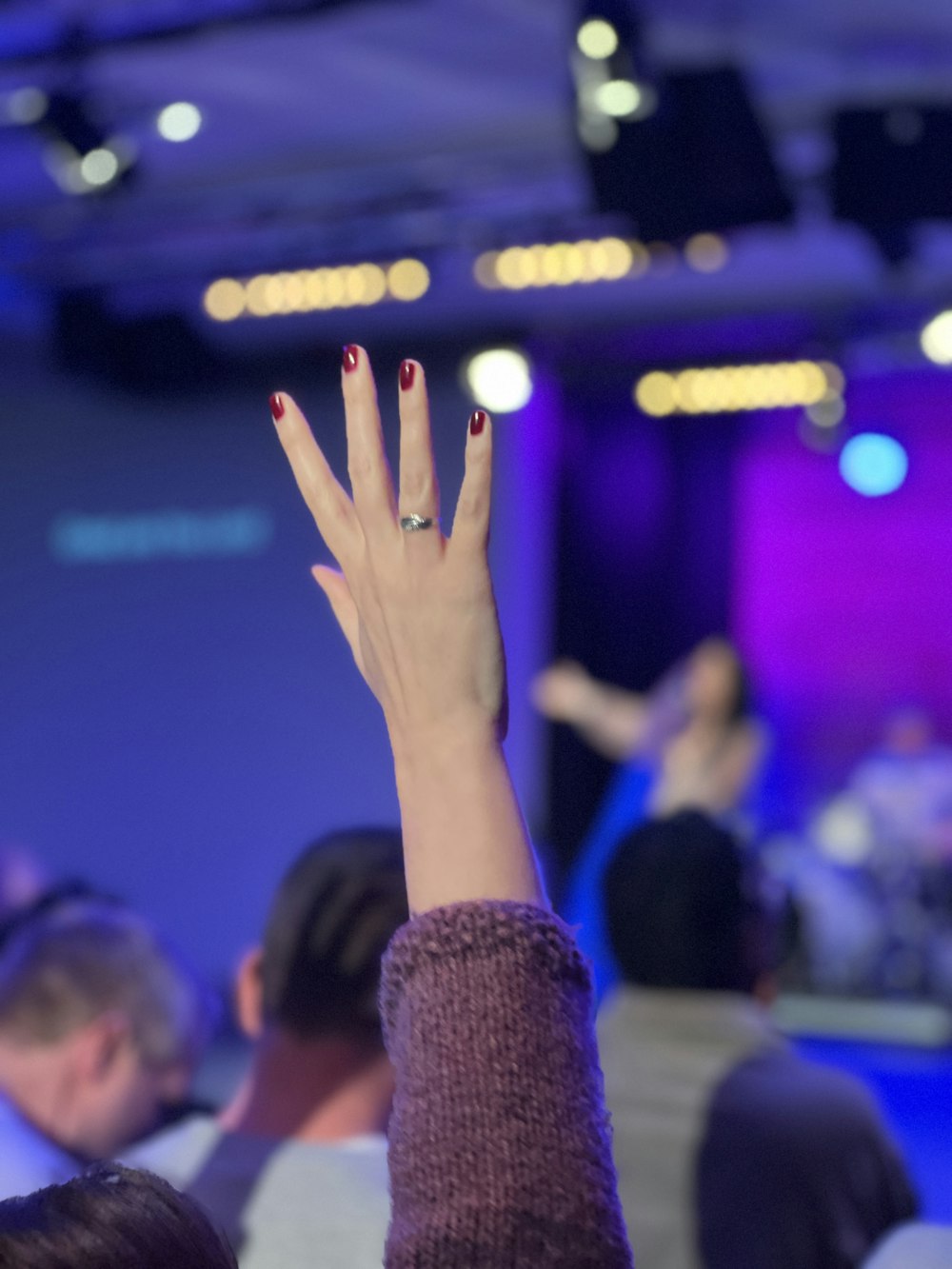 a woman with her hand up in the air