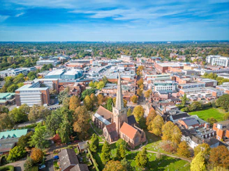 an aerial view of a city with trees and buildings