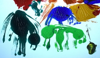 An abstract composition of colorful paint splashes on canvas.