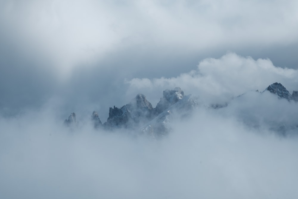 a group of mountains covered in clouds in the distance
