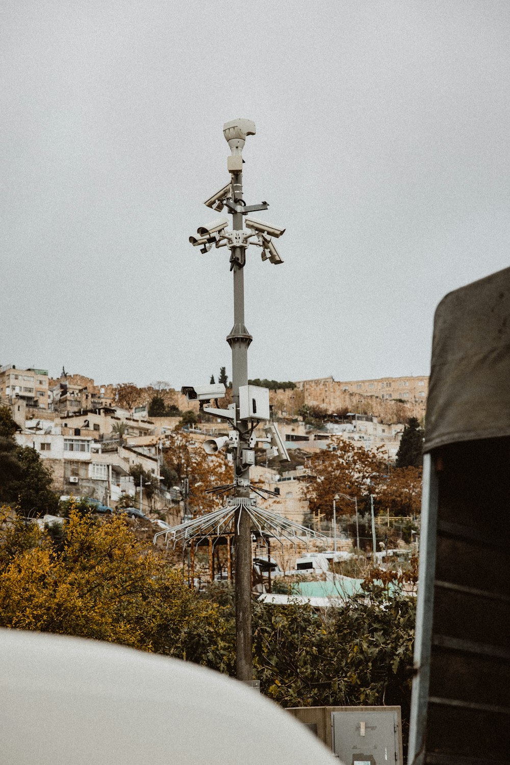 a street light with a city in the background