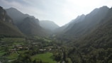 A serene landscape of the Kashmir valley with fruit trees.