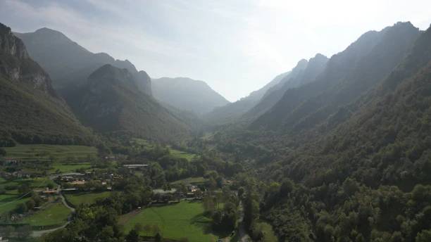 Peaceful valley landscape with mountains and early morning light near Hotel Vardaan Hills.