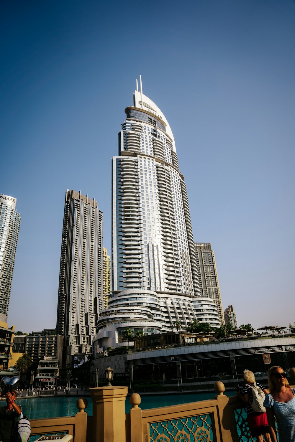 a group of people standing in front of a tall building