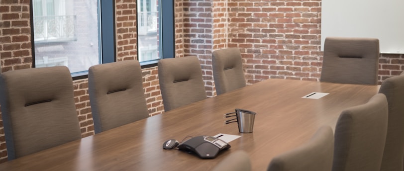 a conference room with a wooden table and chairs