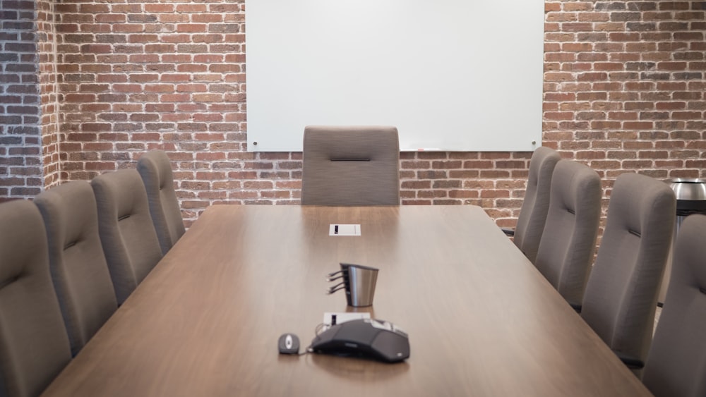 a conference room with a projector screen and chairs
