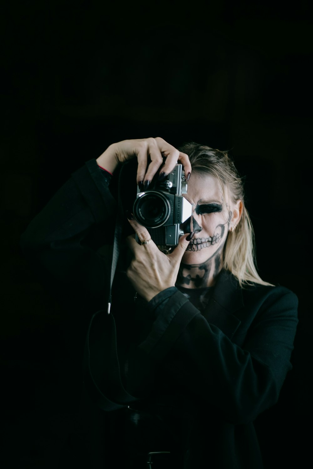 a woman taking a picture with a camera