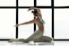a woman is doing a yoga pose in front of a window