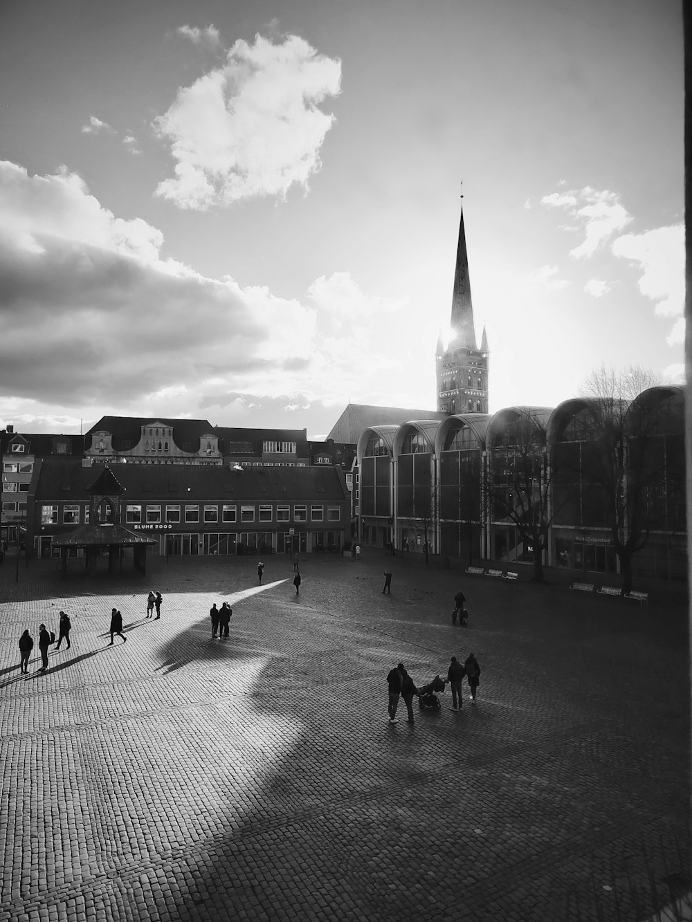 a black and white photo of people walking around