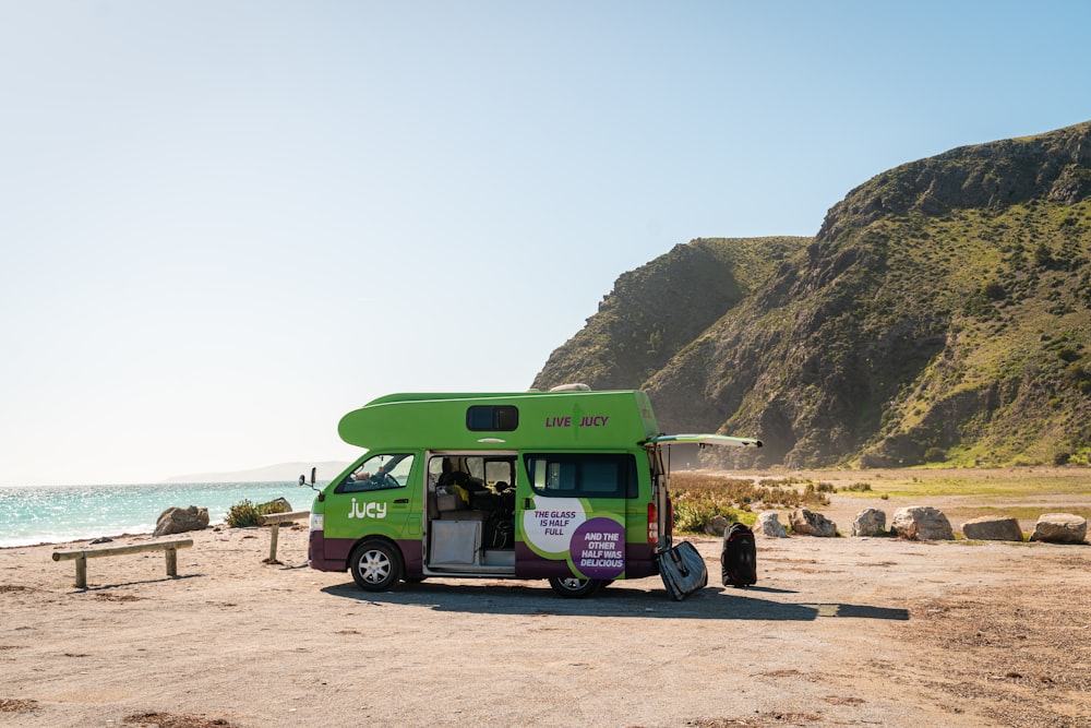 a food truck parked on the side of a beach