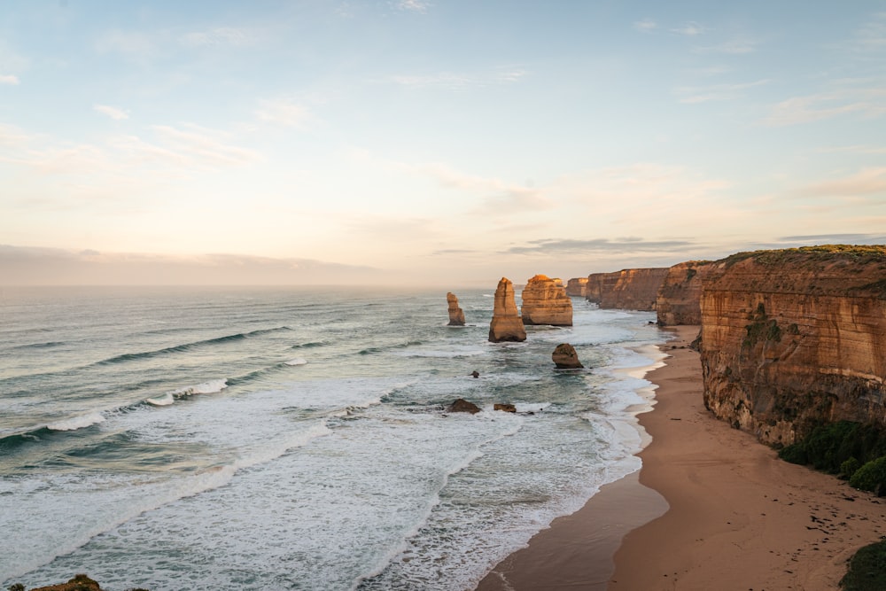 a view of a beach with a cliff in the background