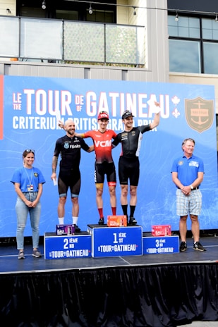 A group of athletes celebrating their achievements on a podium after a competition.