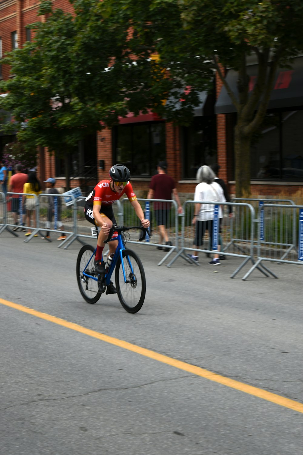 a man riding a bike down a street