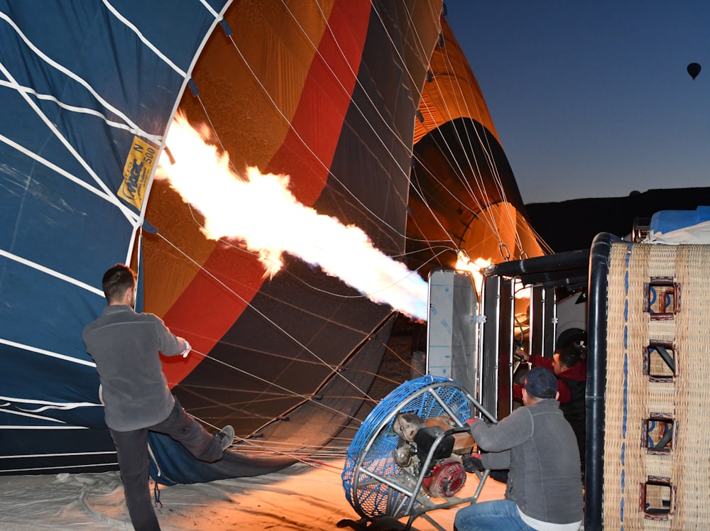 a group of people working on a hot air balloon