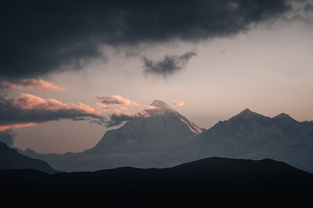 a view of a mountain with clouds in the sky