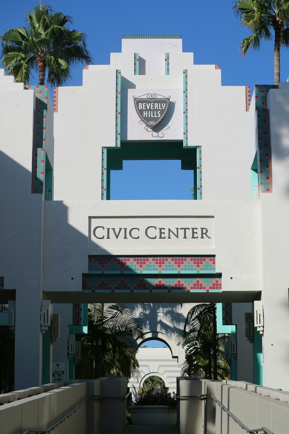 the entrance to the civic center with palm trees in the background
