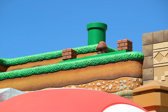 A colorful, blocky gaming scene with cute icons from Roblox and Minecraft, featuring pastel pink, purple, teal, and sky blue colors.