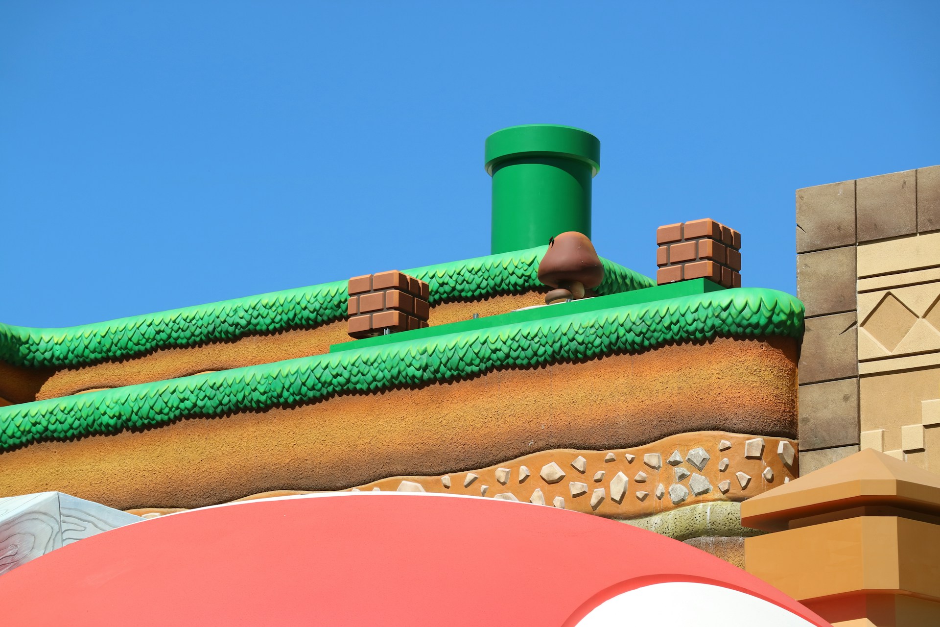 A colorful 2D platformer level featuring a cheerful character jumping between floating islands with coins and enemies.