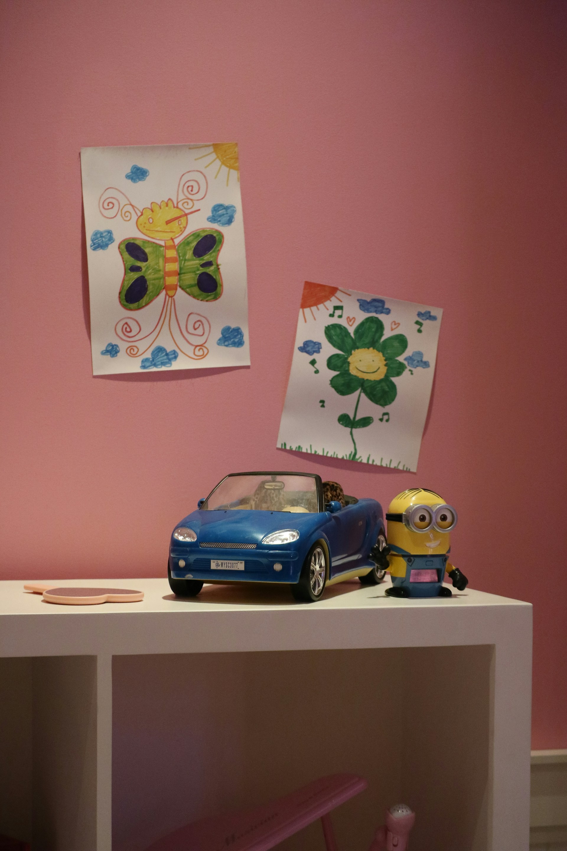 A vibrant children's bedroom wall featuring colorful vertical prints with futuristic designs.