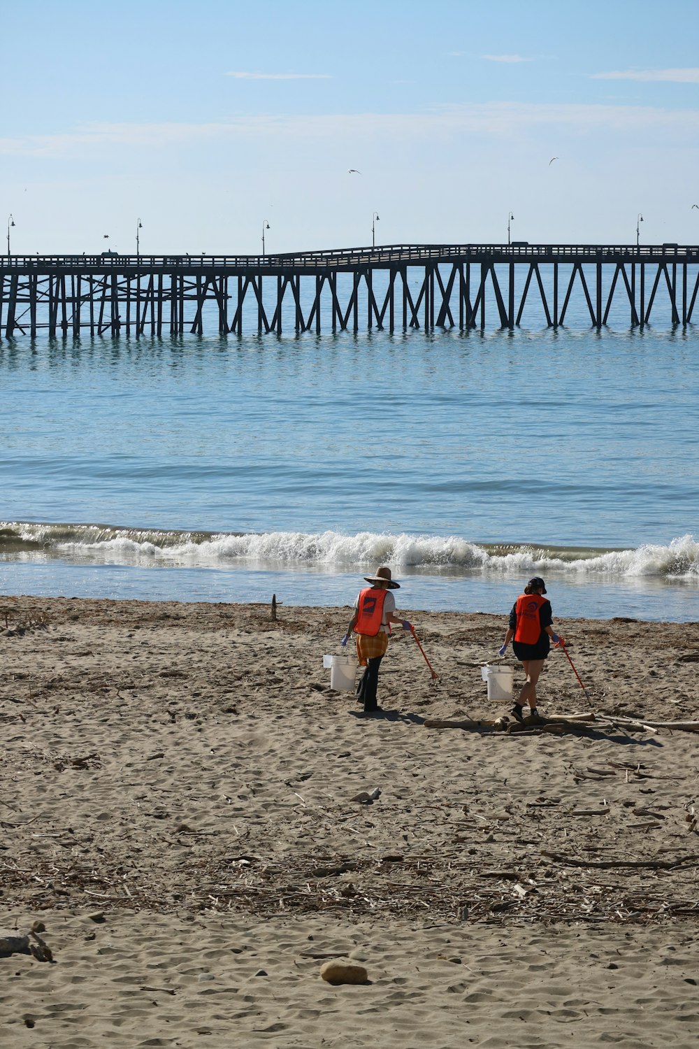 a couple of people that are standing in the sand