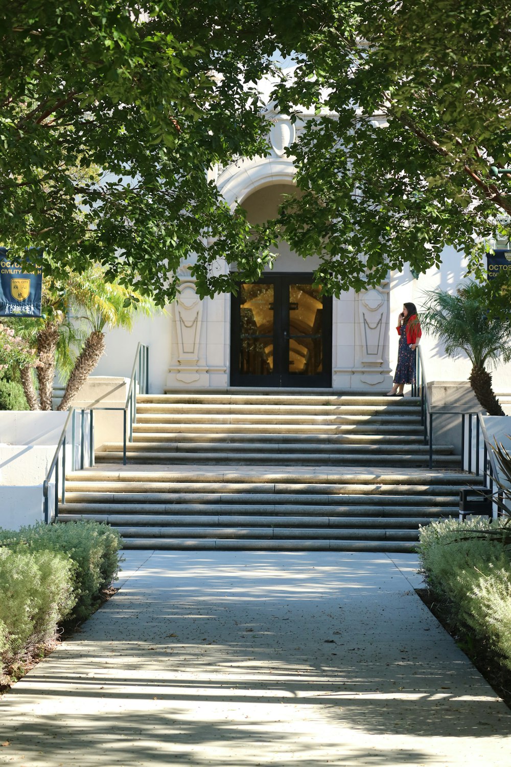 a woman standing at the top of a set of stairs