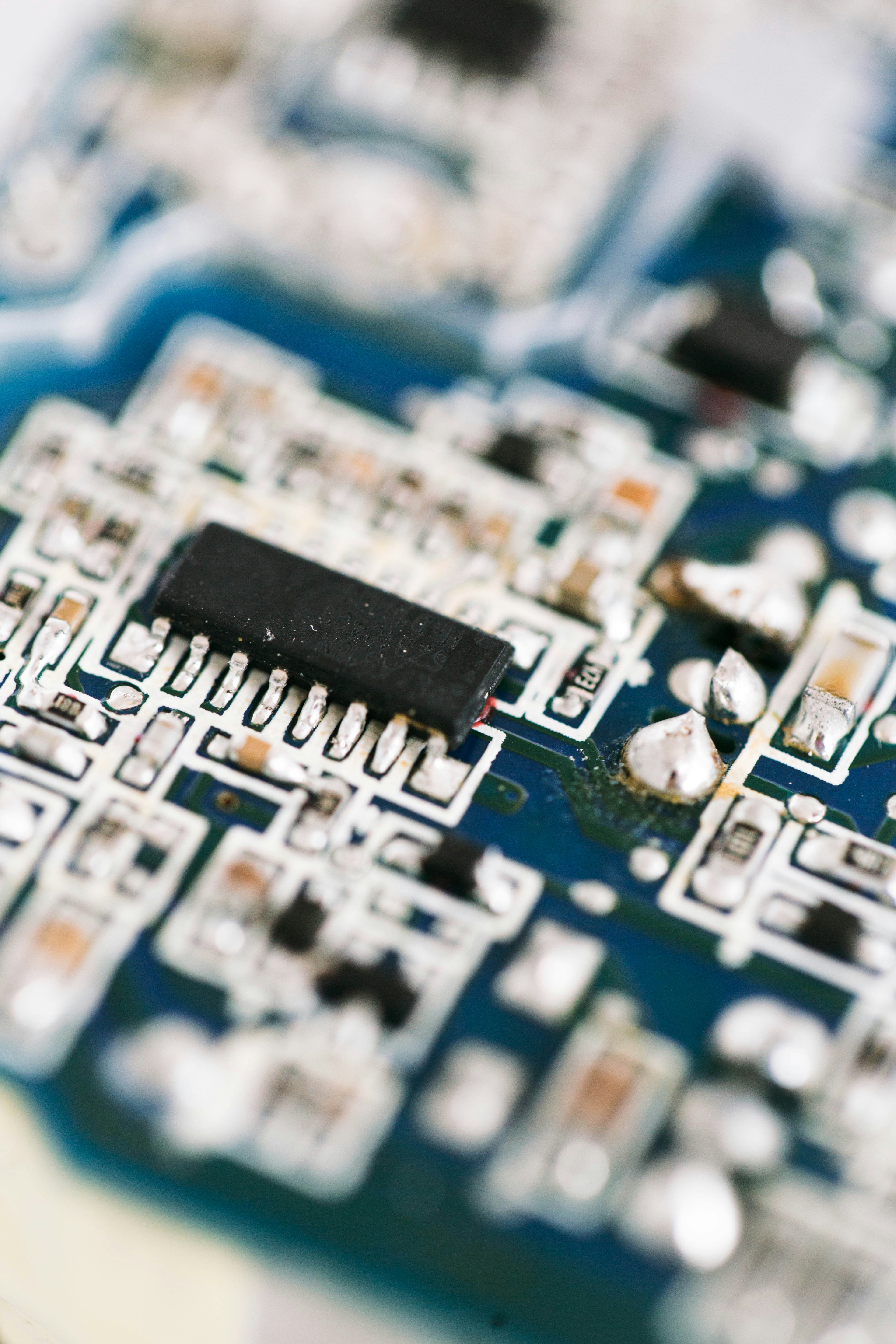a close up of a circuit board with a black chip