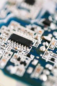 a close up of a circuit board with a black chip