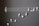 A creative arrangement of white earphones mimicking musical notes on a blackboard, with a treble clef and staff lines providing a musical context.