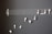 A creative arrangement of white earphones mimicking musical notes on a blackboard, with a treble clef and staff lines providing a musical context.