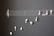 A creative arrangement of white earphones mimicking musical notes on a blackboard, with a treble clef and staff lines providing a musical context.