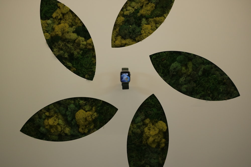 a watch sitting on top of a white wall