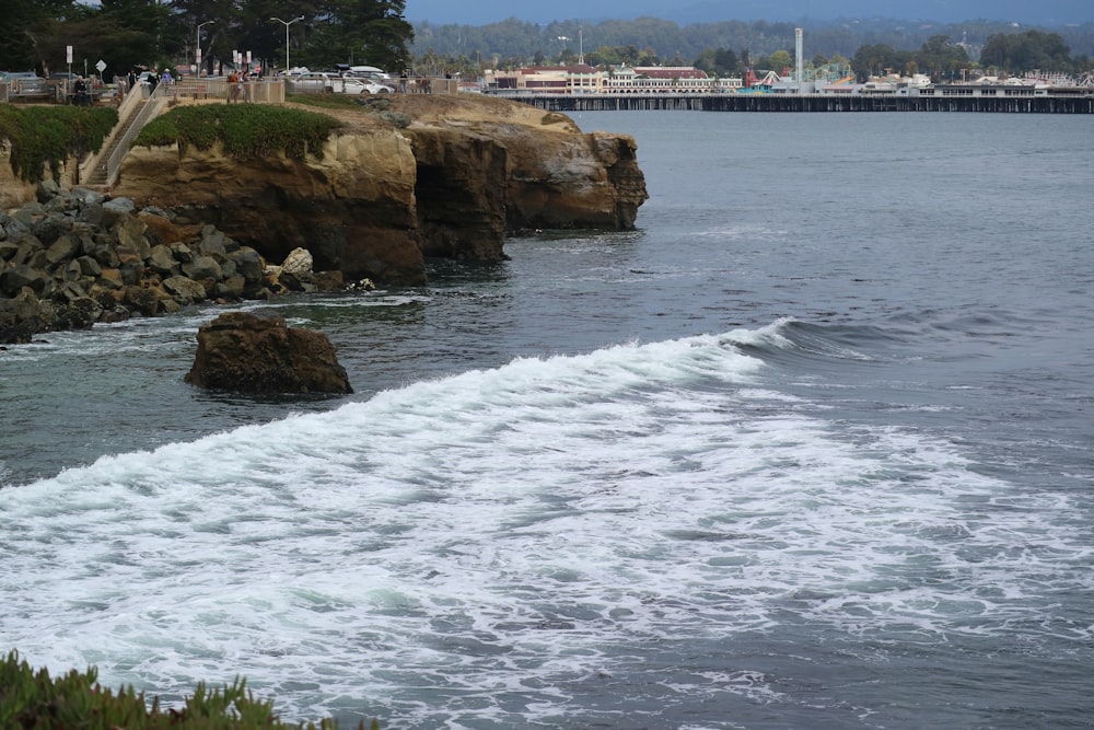 a large body of water next to a rocky shore