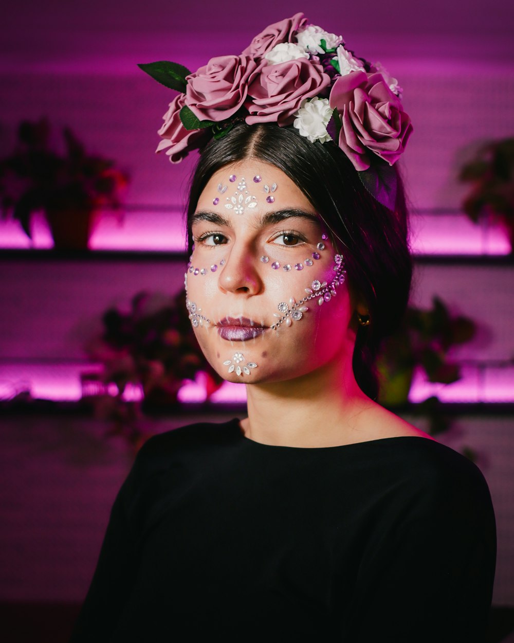 a woman with face paint and flowers on her head