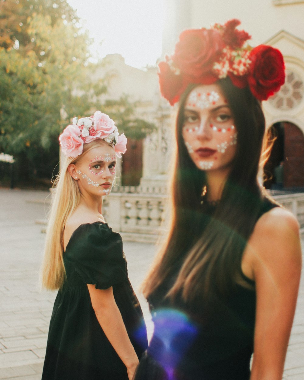 two beautiful young women standing next to each other