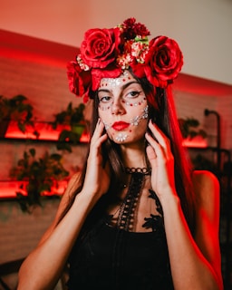 a woman with makeup and flowers on her head