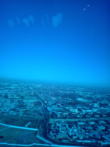 A vibrant aerial view of Burao city showing bustling streets and key municipal landmarks under a clear sky.