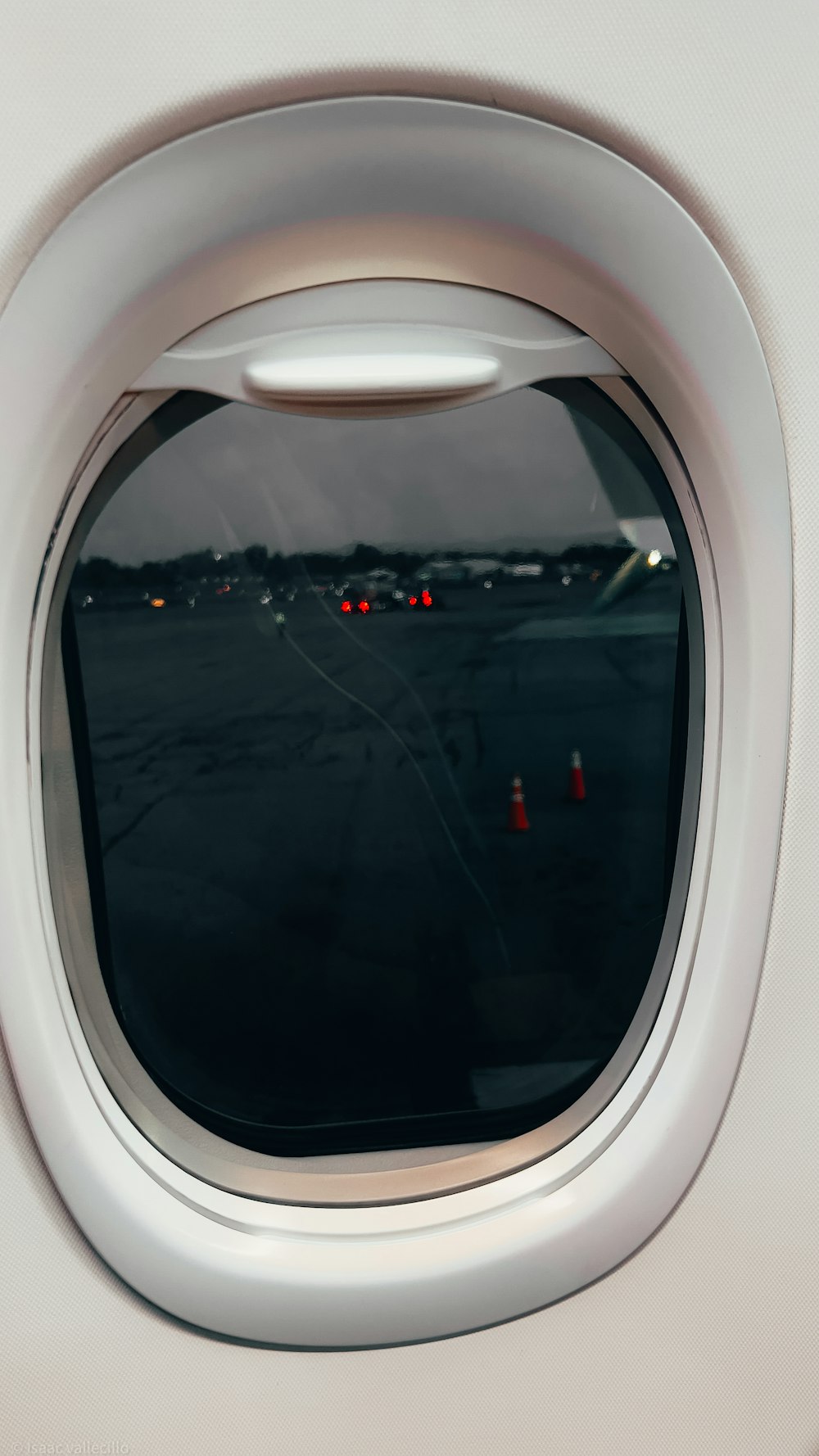 an airplane window with a view of a runway